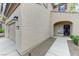 Inviting front entrance with stucco exterior, arched entryway, and a well-kept front yard at 2617 Romarin Ter, Henderson, NV 89044