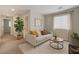 Living area showcasing modern decor, neutral sofa, and indoor plants for a welcoming atmosphere at 2617 Romarin Ter, Henderson, NV 89044