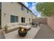 Cozy outdoor patio with comfortable seating, fire pit, and dining area for enjoying outdoor relaxation and entertainment at 2617 Romarin Ter, Henderson, NV 89044