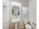 Bright powder room with pedestal sink and chrome fixtures at 2617 Romarin Ter, Henderson, NV 89044