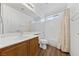 Bathroom with double sinks, wood cabinets, tub and tiled shower at 2682 Korea Ct, Henderson, NV 89052