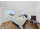 Sunlit bedroom with hardwood floors, large window, and accent chair at 2682 Korea Ct, Henderson, NV 89052