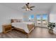 Bedroom with hardwood floors, french doors to balcony and ceiling fan at 2682 Korea Ct, Henderson, NV 89052