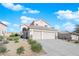 Attractive home boasts a three-car garage and desert-friendly front yard at 2682 Korea Ct, Henderson, NV 89052
