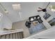 Elevated view of a living room with a black sofa and view from the stairway at 2682 Korea Ct, Henderson, NV 89052