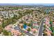 Expansive aerial view of a vibrant neighborhood with lush greenery and well-maintained homes under a sunny sky at 2812 Shadow Creek Cir, Las Vegas, NV 89117