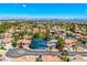Lovely aerial of a desert community with mature landscaping, and tile roofs with a view of mountains in the distance at 2812 Shadow Creek Cir, Las Vegas, NV 89117