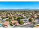 Expansive aerial view of a desert community with lush landscaping, and tile roofs with a view of mountains at 2812 Shadow Creek Cir, Las Vegas, NV 89117