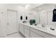 Bright bathroom featuring double sinks, quartz counters, and wall-mounted towel racks at 283 Fossil Falls St, Henderson, NV 89015