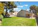 Lush backyard featuring mature trees and a well-manicured lawn, perfect for outdoor activities at 289 Garwood Ct, Henderson, NV 89074