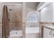 Bathroom featuring a soaking tub, separate shower with tile surround, and tiled walls at 289 Garwood Ct, Henderson, NV 89074