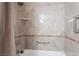 Tiled shower with grab bar features a beige tile surround with built-in niche and modern shower head at 289 Garwood Ct, Henderson, NV 89074