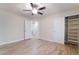 This bedroom features wood-look tile floors, a ceiling fan, and ample closet space at 289 Garwood Ct, Henderson, NV 89074