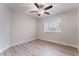 This cozy bedroom has wood-look tile floors, a ceiling fan, and a window with shutters at 289 Garwood Ct, Henderson, NV 89074