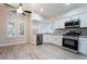 Modern kitchen featuring stainless steel appliances, white cabinetry, and ample natural light from large windows at 289 Garwood Ct, Henderson, NV 89074