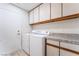 The laundry room features white washer and dryer, granite counters, and modern cabinets at 289 Garwood Ct, Henderson, NV 89074
