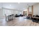 Open-concept living space with hardwood floors, brick fireplace, stylish furnishings, and ample natural light at 289 Garwood Ct, Henderson, NV 89074
