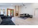 Cozy living room showcasing a brick fireplace, plush sofas, and access to outdoor space at 289 Garwood Ct, Henderson, NV 89074