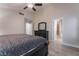 Main bedroom featuring a ceiling fan, wood-look tile flooring, a window, contemporary furnishings, and ensuite bathroom access at 289 Garwood Ct, Henderson, NV 89074