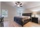 Main bedroom features a ceiling fan, wood-look tile flooring, a window, and contemporary furnishings at 289 Garwood Ct, Henderson, NV 89074