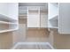 Organized walk-in closet with custom white shelving, drawers, and wood-look tile flooring at 289 Garwood Ct, Henderson, NV 89074
