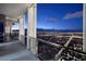 Balcony with glass railings overlooking city lights at night at 4381 W Flamingo Rd # 5502, Las Vegas, NV 89103
