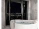 Modern bathroom featuring a jacuzzi tub overlooking a stunning cityscape, with marble accents at 4381 W Flamingo Rd # 5502, Las Vegas, NV 89103