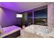 Luxurious bathroom featuring a jacuzzi tub with stunning city views, complemented by elegant design and mood lighting at 4381 W Flamingo Rd # 5502, Las Vegas, NV 89103