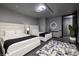 Bedroom with two beds, stylish lighting, and a patterned rug at 4381 W Flamingo Rd # 5502, Las Vegas, NV 89103