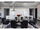 Elegant dining room with modern lighting fixture and open view to the kitchen with a large island at 4381 W Flamingo Rd # 5502, Las Vegas, NV 89103
