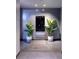 Modern hallway with gray walls and tiled floors, with plants on either side of a mirrored door at 4381 W Flamingo Rd # 5502, Las Vegas, NV 89103