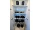 Organized white kitchen cabinet featuring bowls, plates, mugs, glasses, and pots on multiple shelves at 4381 W Flamingo Rd # 5502, Las Vegas, NV 89103