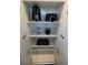 White kitchen cabinet showcasing a black Smeg coffee maker, toaster, blender and bakeware on the shelves at 4381 W Flamingo Rd # 5502, Las Vegas, NV 89103