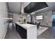 Sleek kitchen with a modern island, black cabinets, and open dining area, perfect for entertaining at 4381 W Flamingo Rd # 5502, Las Vegas, NV 89103
