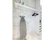 Well-organized laundry room with shelving and ironing board at 4381 W Flamingo Rd # 5502, Las Vegas, NV 89103