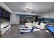 Bright living room with floor-to-ceiling windows offering city views, complemented by a modern sectional and pool table at 4381 W Flamingo Rd # 5502, Las Vegas, NV 89103