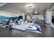 Spacious living room with a modern white sectional sofa, pool table, and unique ocean-themed mural at 4381 W Flamingo Rd # 5502, Las Vegas, NV 89103