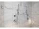Modern shower with marble tiling, multiple showerheads, and sleek fixtures, offering a spa-like experience at 4381 W Flamingo Rd # 5502, Las Vegas, NV 89103
