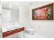 Modern powder room featuring a stylish vanity, toilet, and unique artwork, enhanced by bright lighting at 4471 Dean Martin Dr # 1707, Las Vegas, NV 89103