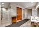 Modern bathroom with stylish tiling, sinks, and towel disposal at 4471 Dean Martin Dr # 1707, Las Vegas, NV 89103