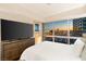 Bedroom featuring a large window with great views of the city, dresser and tv at 4471 Dean Martin Dr # 1707, Las Vegas, NV 89103
