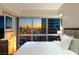 Modern bedroom with a large window with an expansive view of the city at 4471 Dean Martin Dr # 1707, Las Vegas, NV 89103