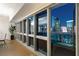 Hallway with floor to ceiling windows showing the illuminated city view at 4471 Dean Martin Dr # 1707, Las Vegas, NV 89103