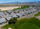 Wide angle aerial view showcasing community neighborhood, golf course, mountain views, and expansive landscape at 4557 E Cactus Canyon Dr, Pahrump, NV 89061