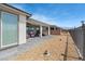 Well-maintained backyard with stone tile and rock landscaping, enhanced by an outdoor ceiling fan for relaxation at 4557 E Cactus Canyon Dr, Pahrump, NV 89061