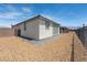This backyard is surrounded with rock landscaping and a brick tiled patio at 4557 E Cactus Canyon Dr, Pahrump, NV 89061