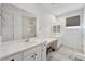Bright bathroom featuring dual sinks, a large mirror, and a glass-enclosed shower at 4557 E Cactus Canyon Dr, Pahrump, NV 89061