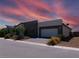 Single-story home with a modern two-tone exterior and a two-car garage at 4557 E Cactus Canyon Dr, Pahrump, NV 89061