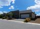 Single-story home with a modern two-tone exterior and a two-car garage at 4557 E Cactus Canyon Dr, Pahrump, NV 89061