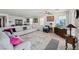 Expansive open-concept living room featuring comfortable seating, abundant natural light, and a modern aesthetic at 4557 E Cactus Canyon Dr, Pahrump, NV 89061
